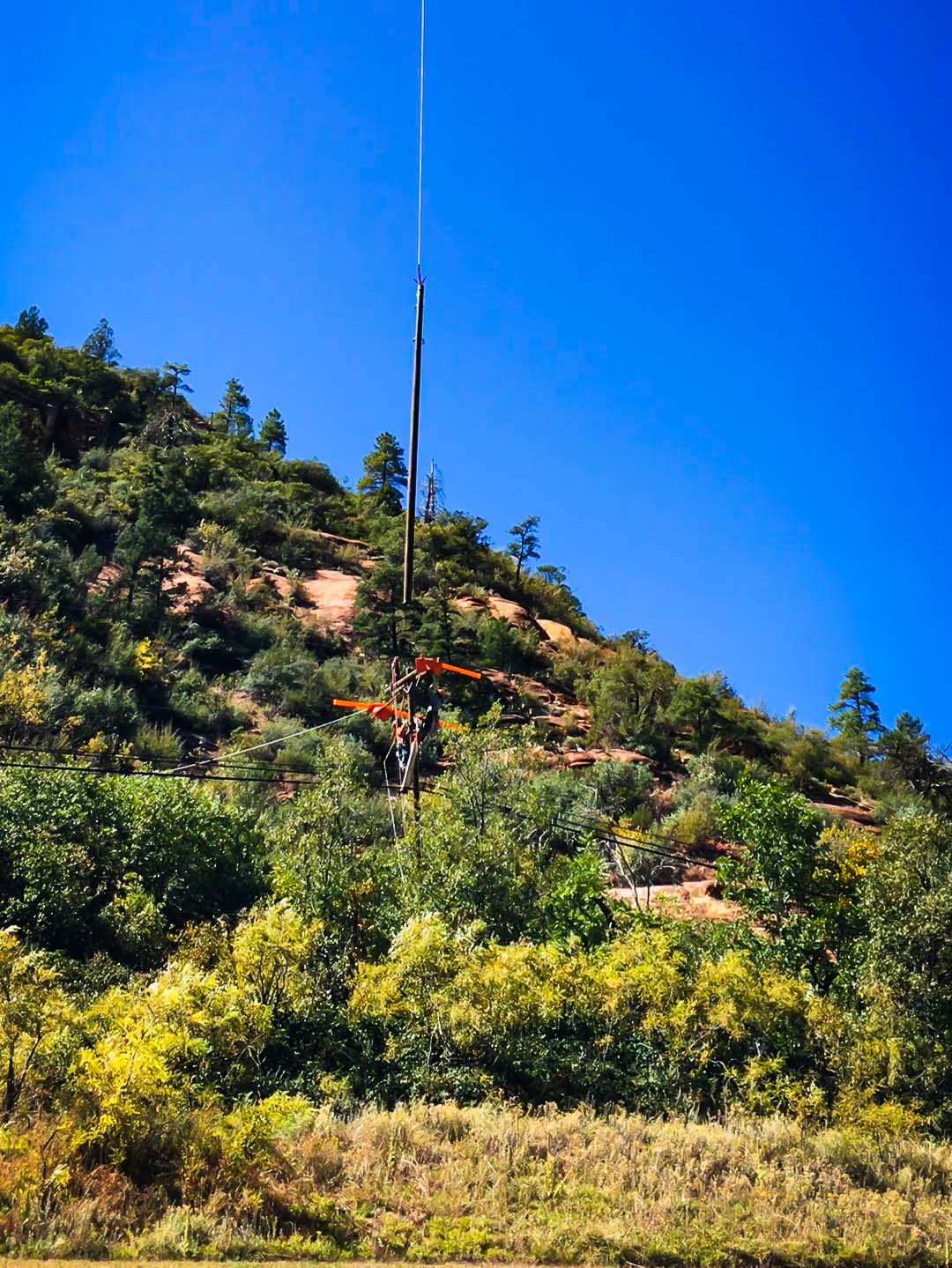 Crane lifting a power line pole