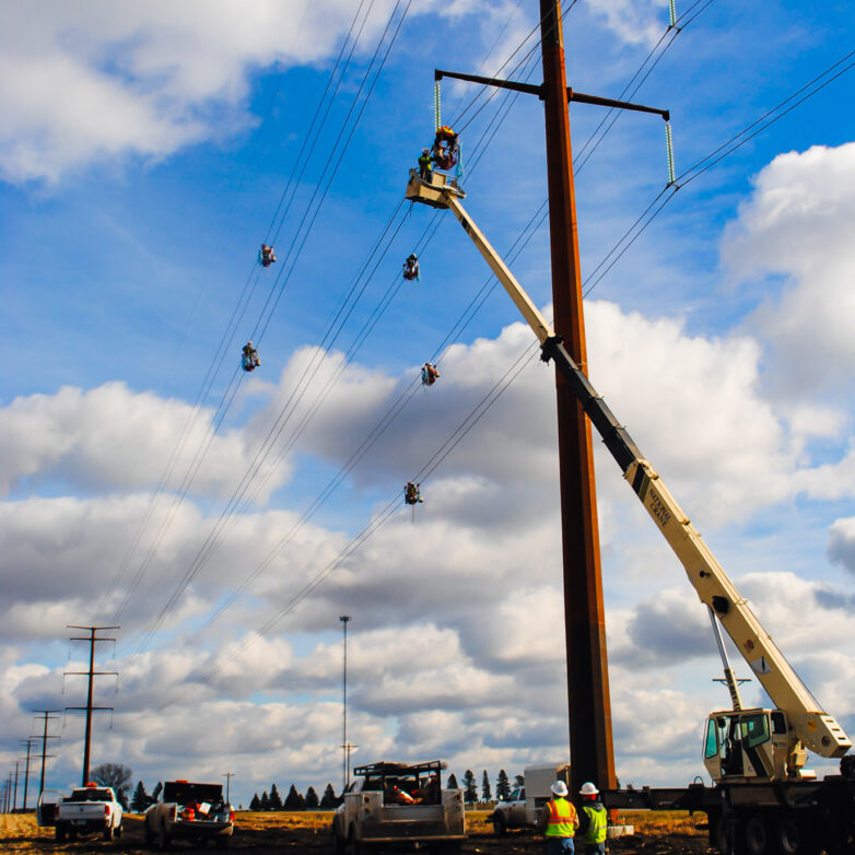 Crane elevates L.E. Myers employee to work on transmission lines