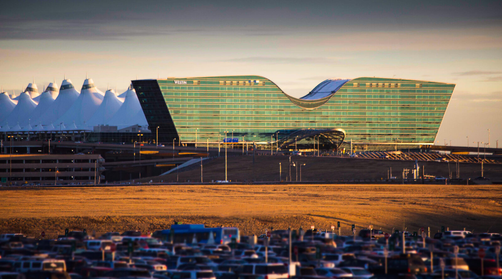 Denver International Airport's terminal and hotel at sunset