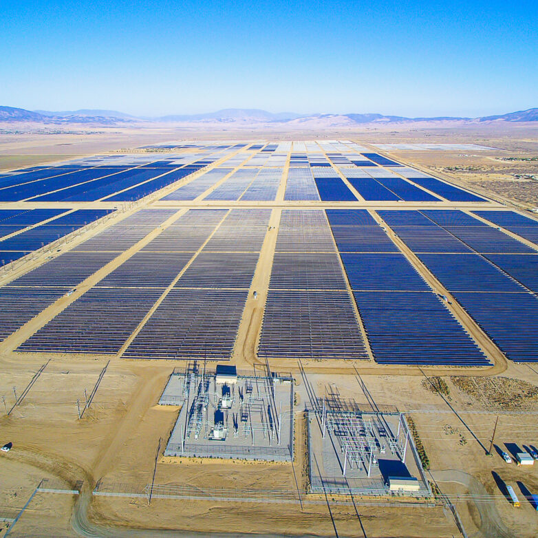 large solar farm in a valley surrounded by hills