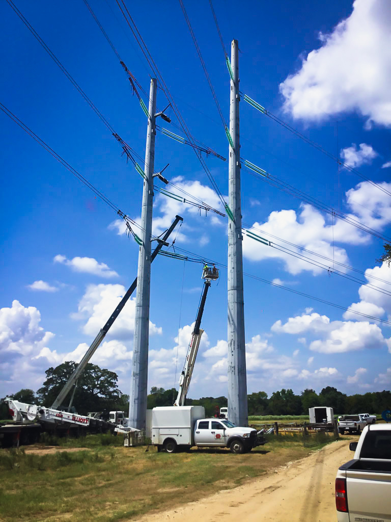L.E. Myers employees in bucket working on transmission lines
