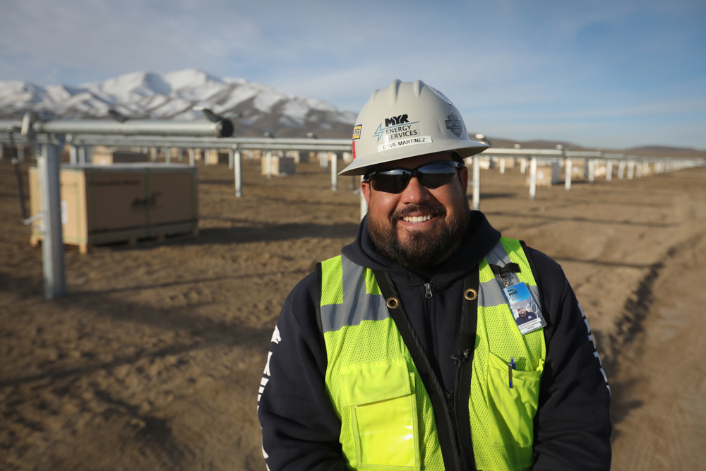 An MYR Energy Services general superintendent stands in front of a solar energy and storage project in Battle Mountain, Nevada.
