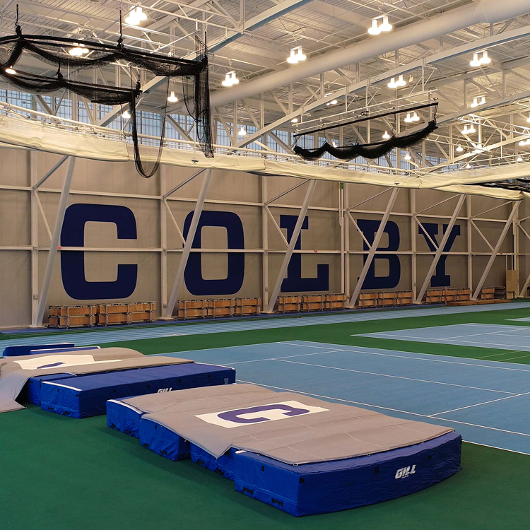 View of mats on artificial turf inside a training facility at Colby Athletics Center