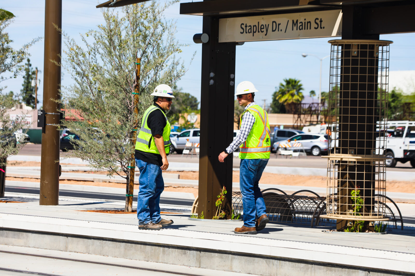 Two construction workers at the Stapley Dr. railway station