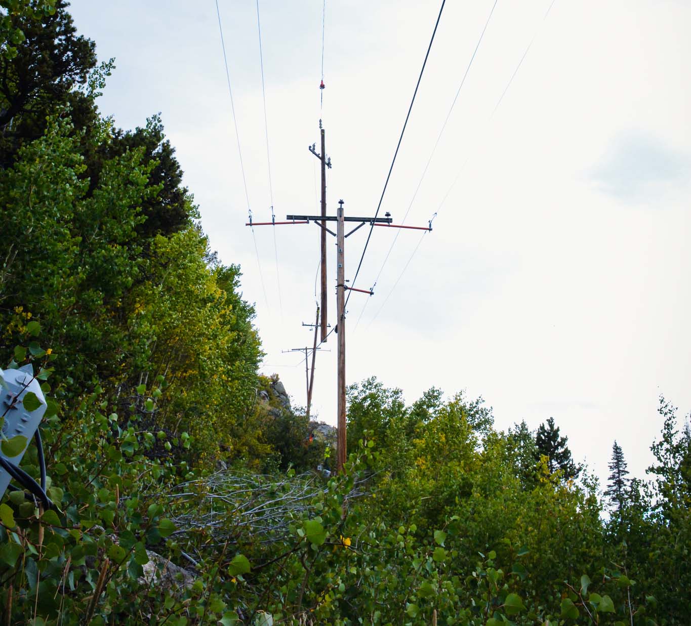 Row of power lines with one being installed